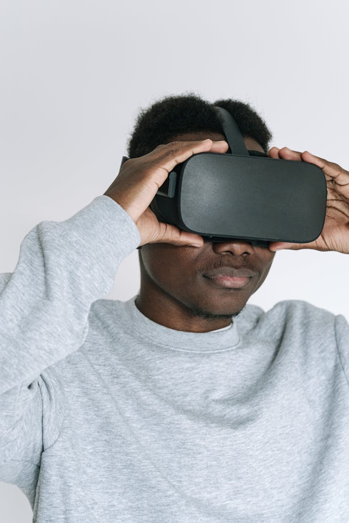 African American man wearing virtual reality headset, immersed in a tech experience. Studio shot.